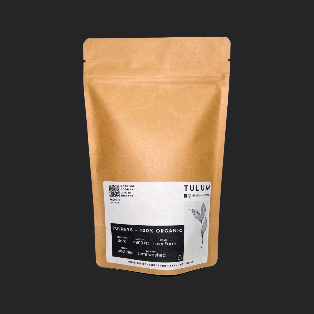 Close-up view of a 100g package of Pulneys 100% organic and Arabica coffee beans, the label highlighting the beans distinct chocolaty and fruity notes.