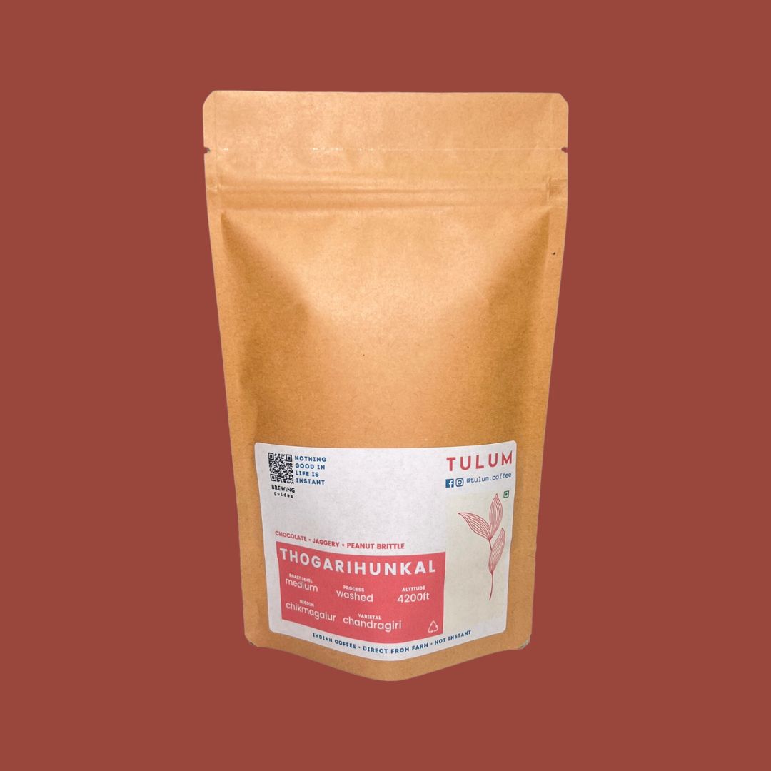 Close up View of Tulum's Thogarihunkal Washed Coffee of 100 grams in brown packets with Jaggery and Peanut Brittle flavour notes.