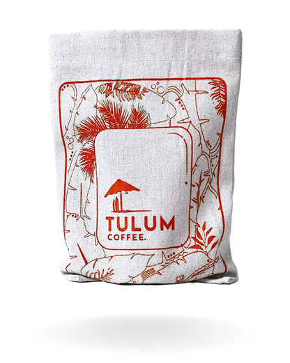 A close up view of Tulum's Thogarihunkal Washed Arabica Coffee Beans in Red cloth bag with Chocolatey notes.