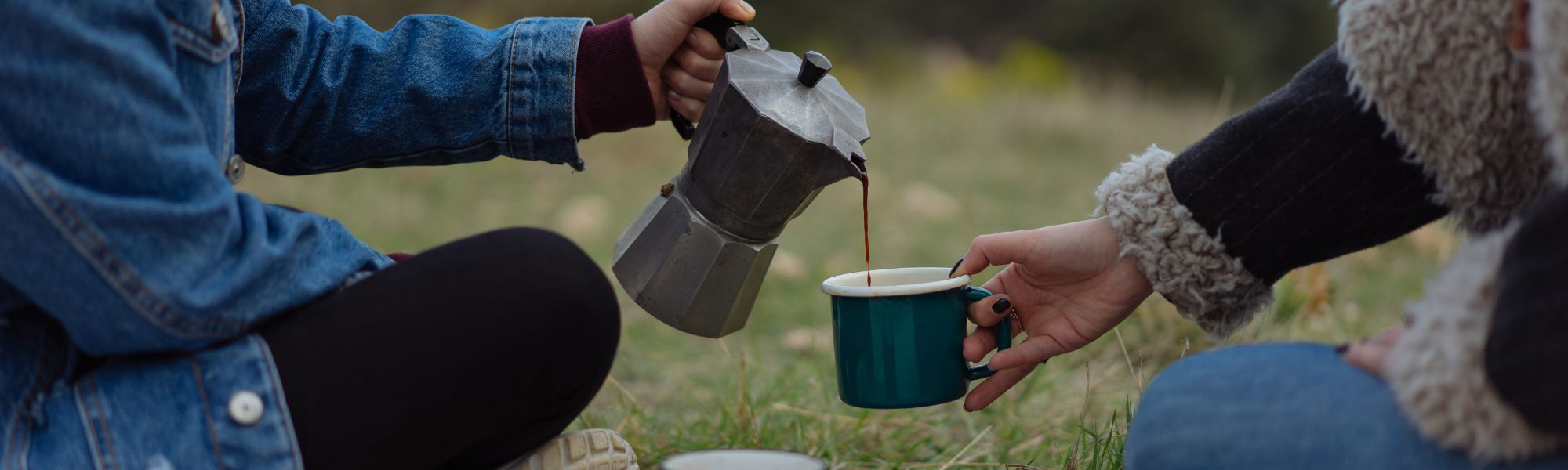 An image of person having coffee in Moka pot and serving it.
